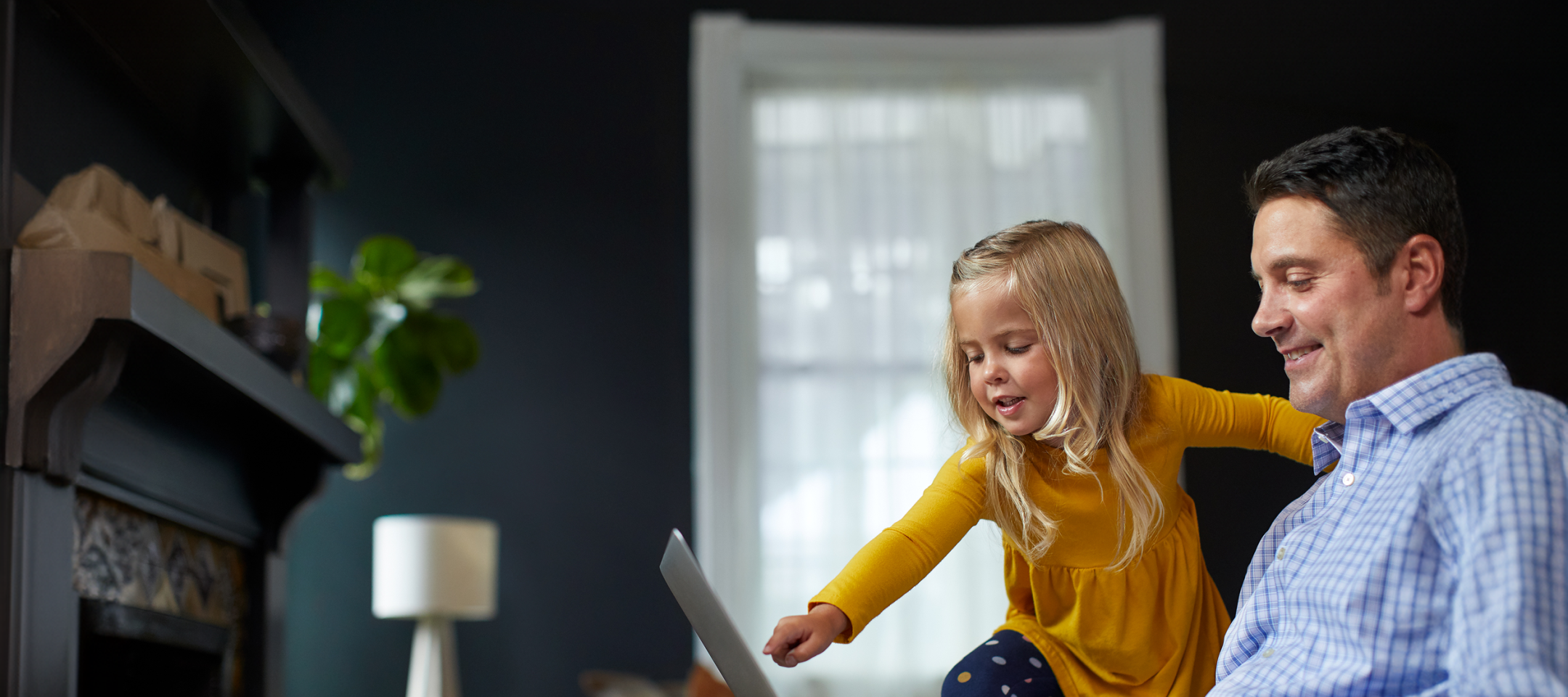 Father and Daughter Pointing to Laptop