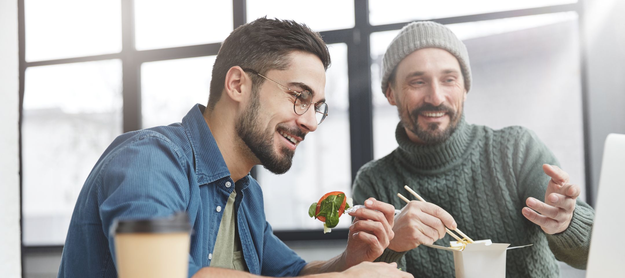 Male Couple Eating Lunch and Choosing Plans