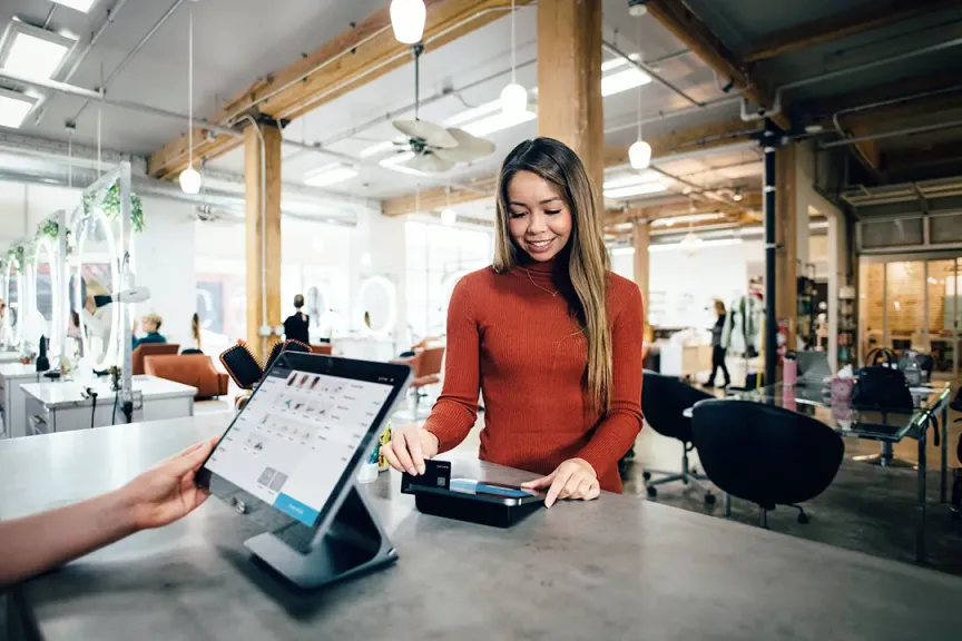 Home goods retail department store processing a transaction from a tablet hybrid screen laptop and payment system connected through fast fibre internet Elevate Package with SmartBiz from WTC Communications Kingston